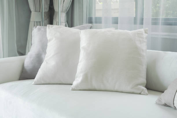 istock White pillows lay on sofa in modern style living room 885986596