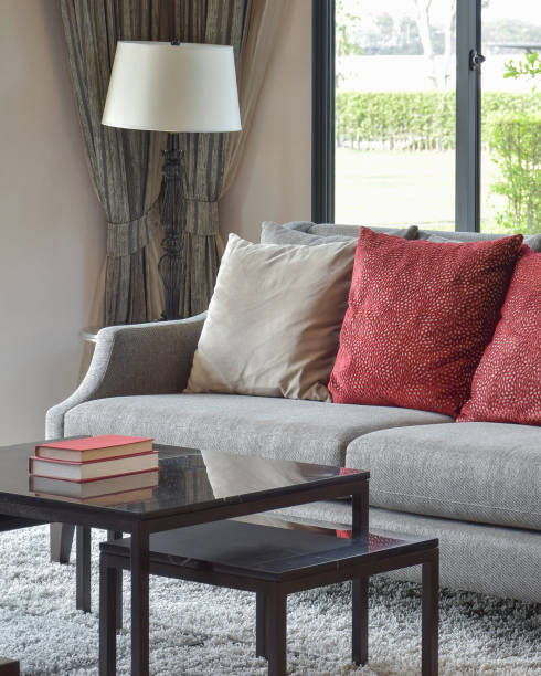 istock modern living room design with red pillows on sofa and decorative table lamp 885989400
