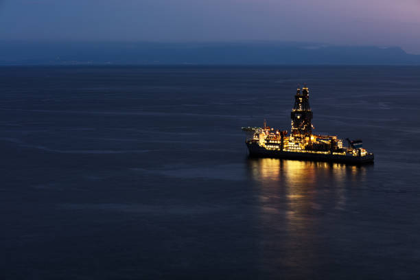 Oil drilling rig on the south cost of Tenerife island on the North Atlantic Ocean Offshore oil drilling rig on the south cost of Tenerife island on the North Atlantic Ocean. The sun has set revealing a beautiful light show floating platform stock pictures, royalty-free photos & images