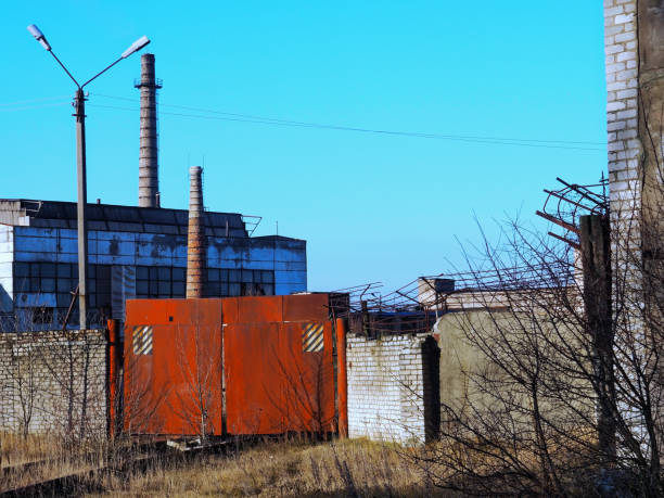 istock Abandoned factory behind fence 885989744