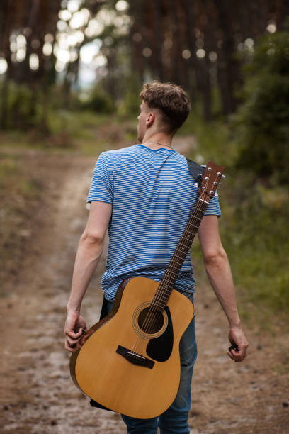 istock Talented guitarist playing forest hiking concept. 885992610