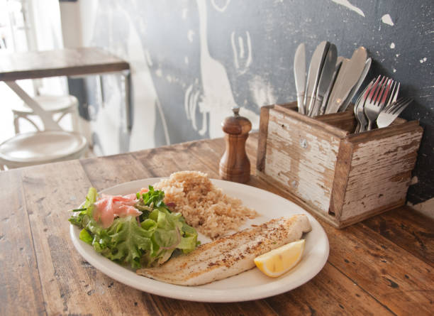children's menu - fish cutlet with rice decorated with sweet pepper and salad.