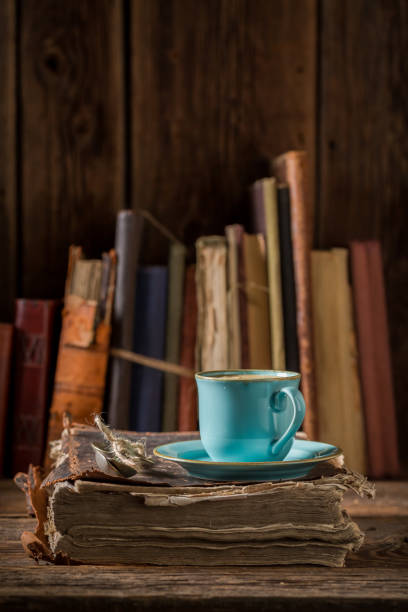 istock Coffee in blue porcelain on book in library 886010356