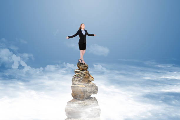 istock Successful businesswoman on stack of rocks 886010418