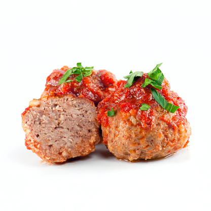 Cooked meatballs with tomato sauce on the white background