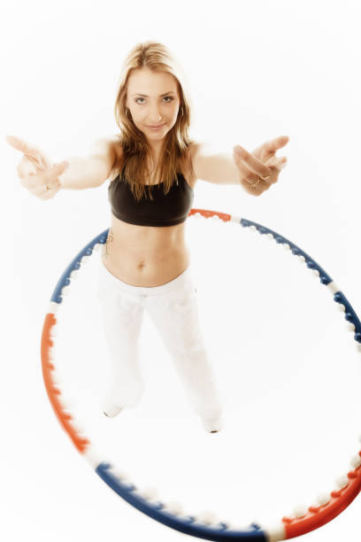 istock sporty fit girl doing exercise with hula hoop. 886013710