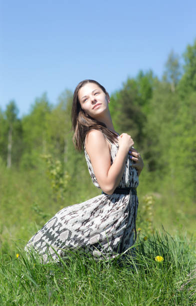 istock girl in dress on grass 886013766