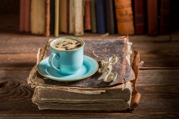istock Homemade cheesecake and coffee on book in library 886016000