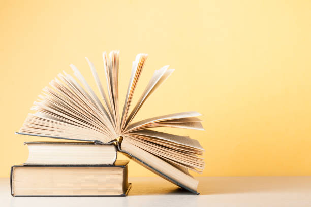 istock Open book, hardback books on wooden table. Education background. Back to school. Copy space for text. 886016764
