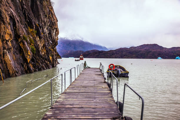 Lago Gray is a glacial lake in February. Pier for boats and pleasure boats. Torres del Paine National Park, Chile. Concept of active and exotic tourism