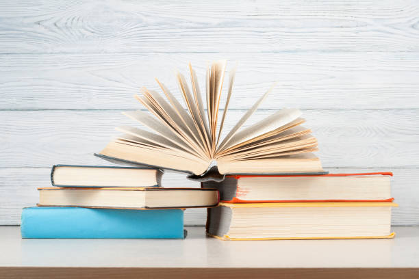 istock Open book, hardback books on wooden table. Education background. Back to school. Copy space for text. 886019654