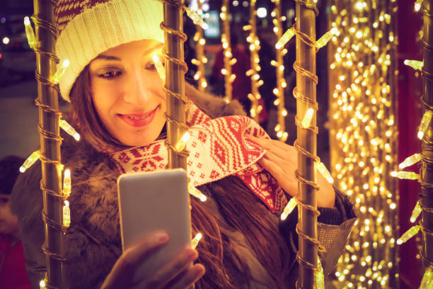 istock woman doing christmas selfie 886020048