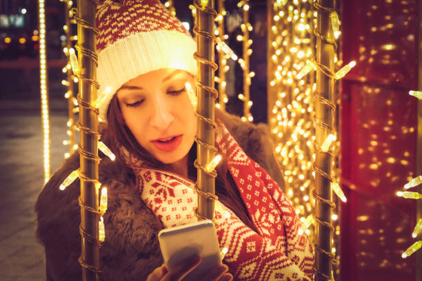 istock woman doing christmas selfie 886022292