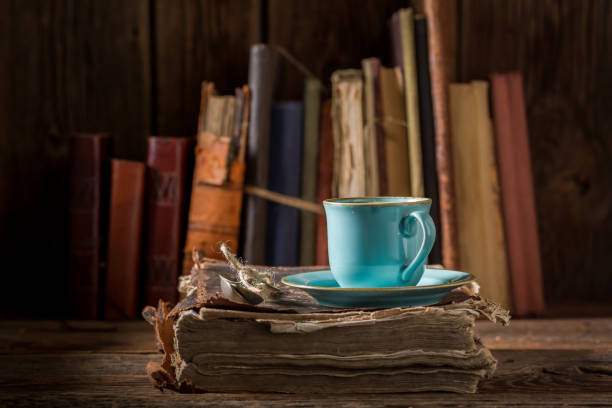 istock Coffee on book in blue porcelain in library 886022766