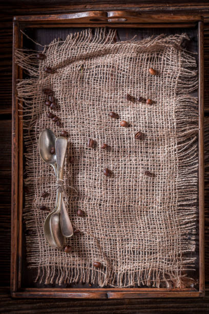 istock Rustic burlap doily and coffee beans on wooden tray 886023090
