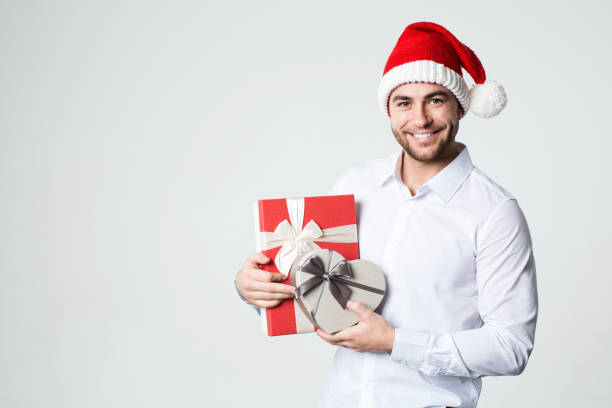 istock Young handsome smiling man with gifts. 886026334