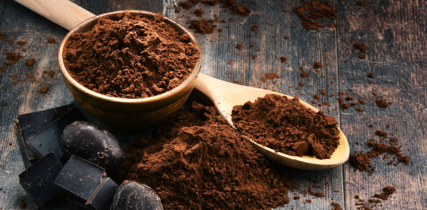 istock Composition with bowl of cocoa powder on wooden table 886026404