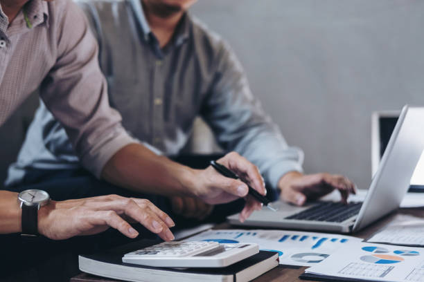 istock Young businessteam working with new startup project. discussing the charts and graphs showing the results at meeting. Business accounting and financial concept 886031670