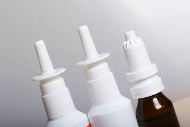 istock Nasal drops and spray stand on the surface. On a white background. 886035562