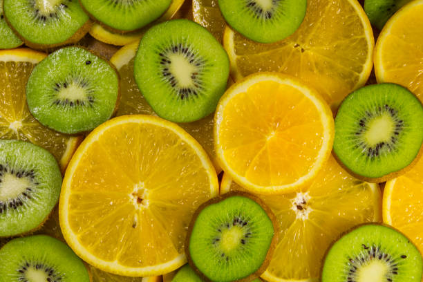 istock Sliced kiwi fruits and oranges for background 886038704