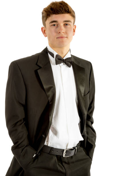 18 year old wearing a tuxedo 18 year old wearing a tuxedo isolated on a white background tuxedo photos stock pictures, royalty-free photos & images