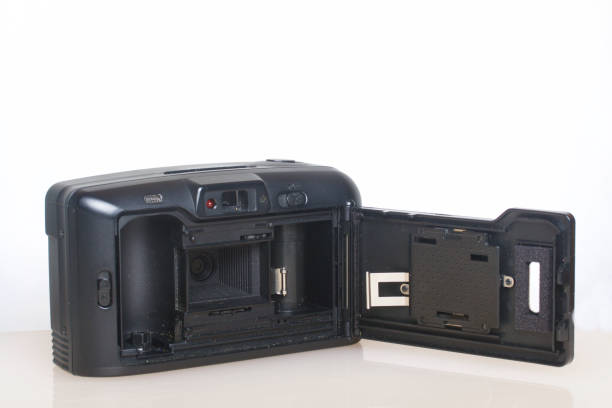 istock Old semi-automatic camera. With an open back cover. Lies on a white surface. View from above. 886046286