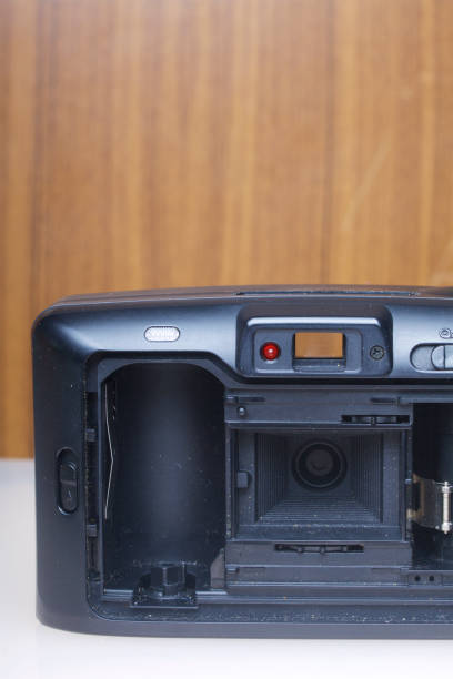 istock Old semi-automatic camera. With an open back cover. Lies on a white surface. View from above. 886046302