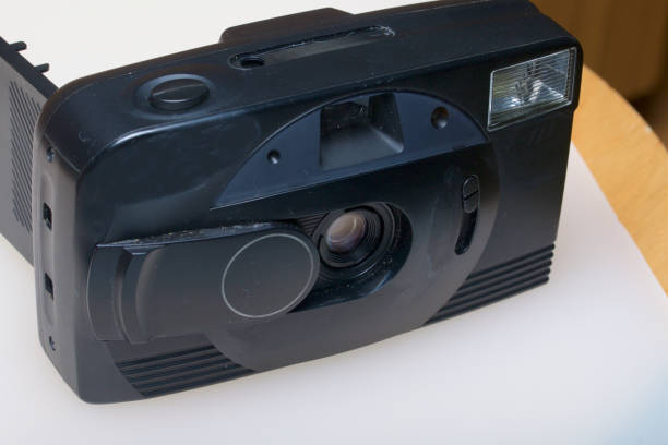 istock Old semi-automatic camera. With an open back cover. Lies on a white surface. View from above. 886046322