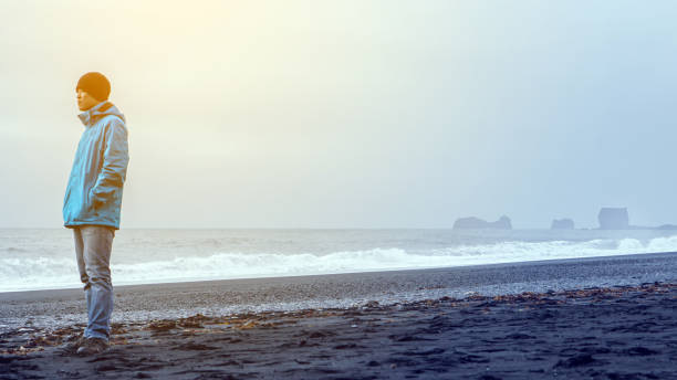 Asina advanture man  at Iceland black beach copy space