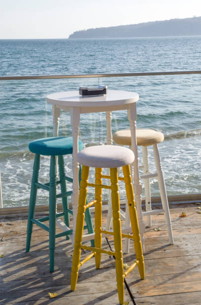 istock Empty round small table and chairs in restaurant on the sea shore 886056578