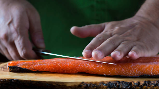 istock Slicing gravlax salmon with a knife 886057210