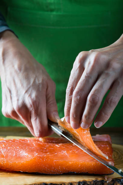 istock Slicing gravlax salmon with a knife 886059480
