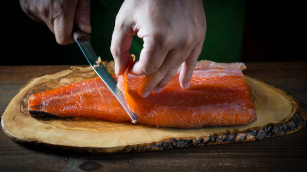 istock Slicing gravlax salmon with a knife 886059754