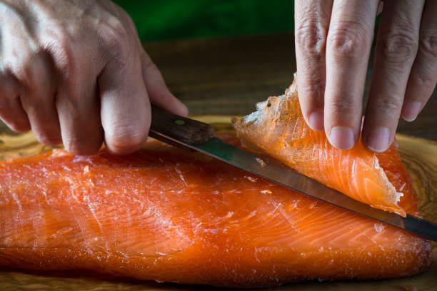 istock Slicing gravlax salmon with a knife 886059968