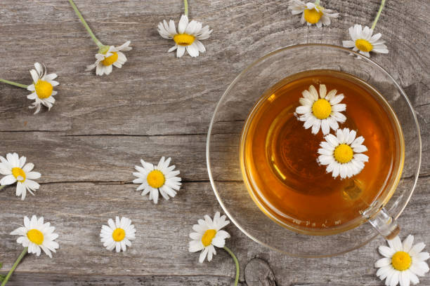 istock cup of green tea with chamomile on old wooden table. top view with copy space 886064752