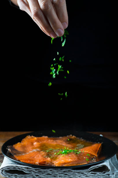 istock Dressing gravlax salmon with olive oil and  dill 886064876