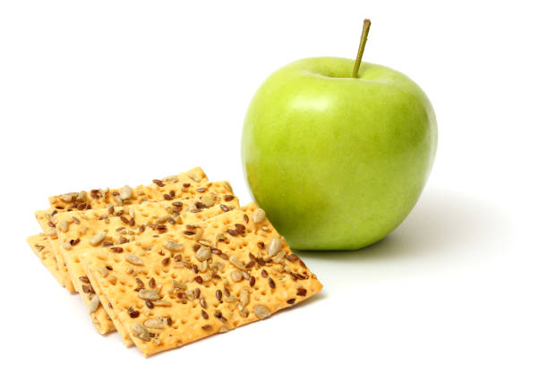 istock Green apple with biscuit isolated on white background 886065450