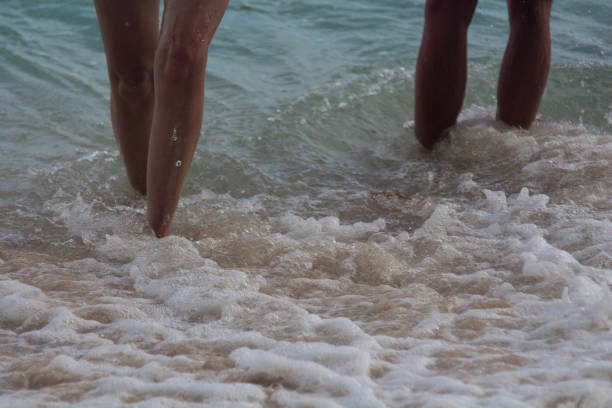 istock Young couple walking out of water 886065964