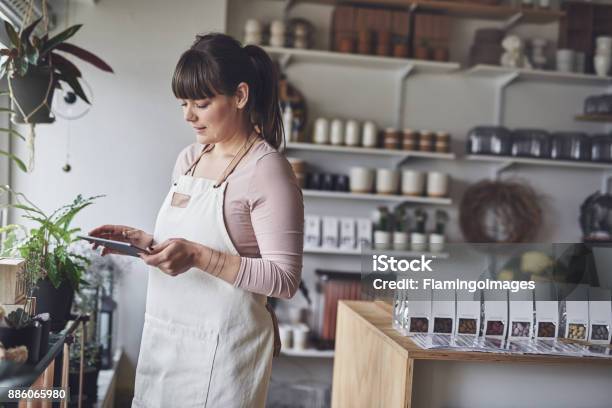 Laughing Florist Arranging A Floral Display In Her Shop Stock Photo - Download Image Now