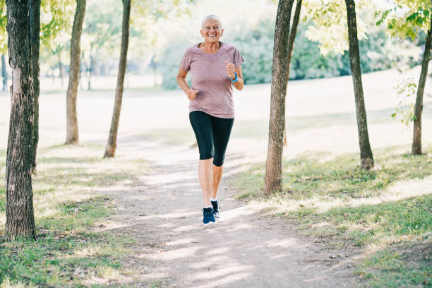 istock Senior woman jogging in the park 886065996