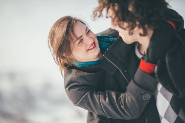 istock Smiling young couple having fun in the snow 886066066