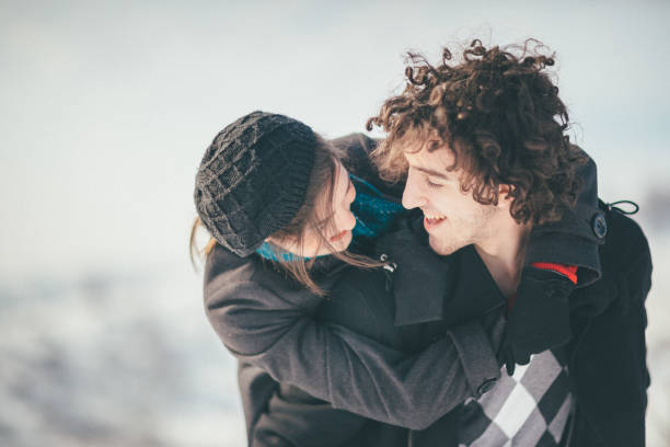 istock Smiling young couple having fun in the snow 886068874