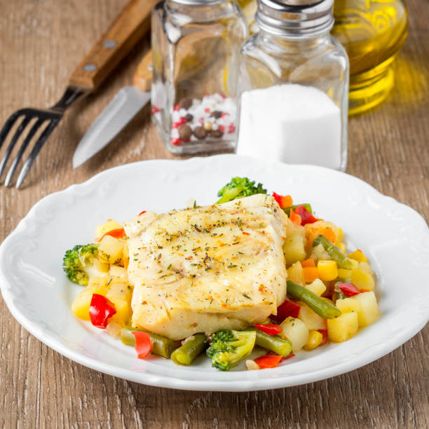 white fish fillet with vegetable stew, cod, sea bass, tilapia, perch, corn, broccoli, potatoes, bell peppers, beans, healthy food, tatsy homemade lunch - sea bass prepared fish food grilled imagens e fotografias de stock