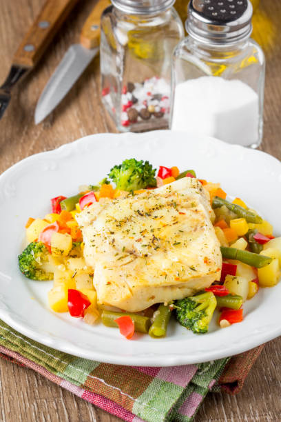 white fish fillet with vegetable stew, cod, sea bass, tilapia, perch, corn, broccoli, potatoes, bell peppers, beans, healthy food, tatsy homemade lunch - sea bass prepared fish food grilled imagens e fotografias de stock