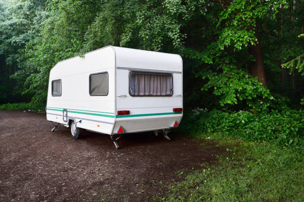 istock Caravan trailer on a forest road, on a summer day 886069634