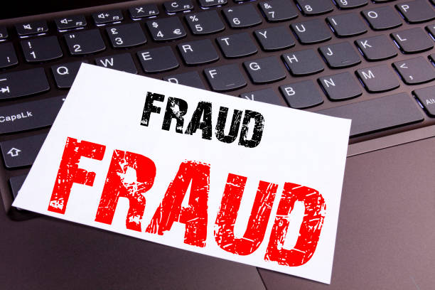 istock Writing Fraud text made in the office close-up on laptop computer keyboard. Business concept for Criminal hacker security prevention Workshop on the black background with copy space 886084294