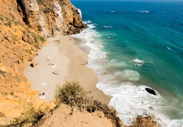 Photo of Dume Cove Malibu, Zuma Beach, emerald and blue water in a quite paradise beach surrounded by cliffs. Dume Cove, Malibu, California, CA, USA