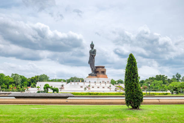 istock Buddha black statue standing in green decoration garden 886084412