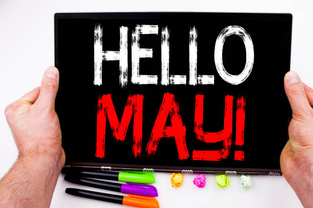istock Hello May. Spring text written on tablet, computer in the office with marker, pen, stationery. Business concept for Criminal hacker security prevention white background with copy space 886089816