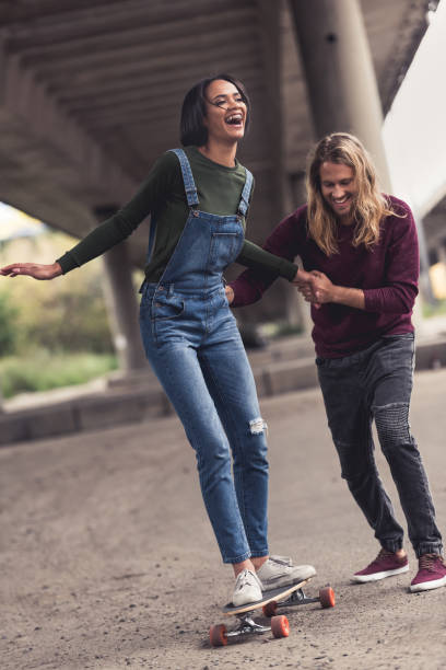 istock woman learning to ride skateboard 886092914